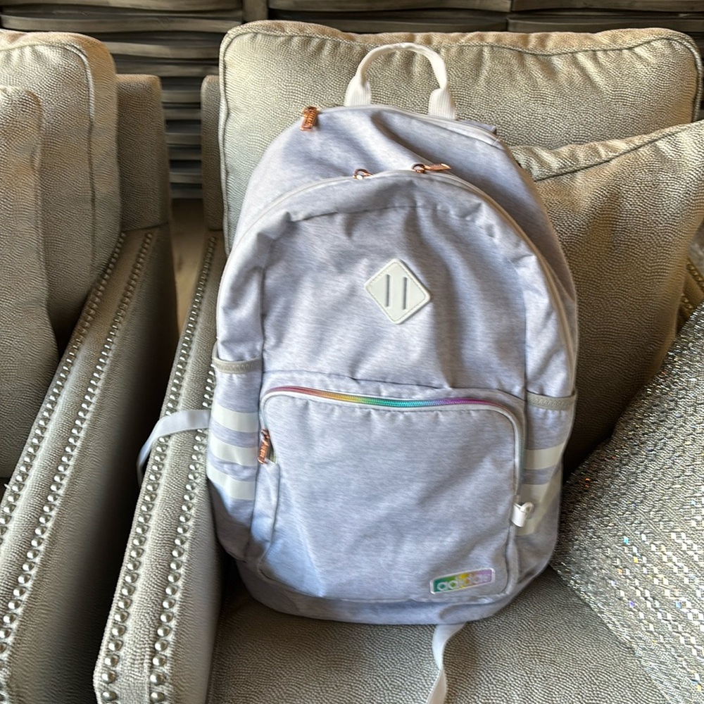 Adidas backpack. Gray/white with subtle colors on adidas logo and front zipper.